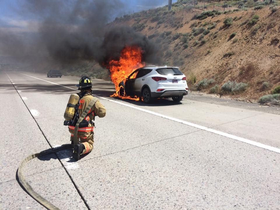 A firefighter puts out a blaze that engulfed a vehicle on U.S. 395 north of Reno on Thursday, June 2, 2016 (Photos courtesy Reno Fire Department)