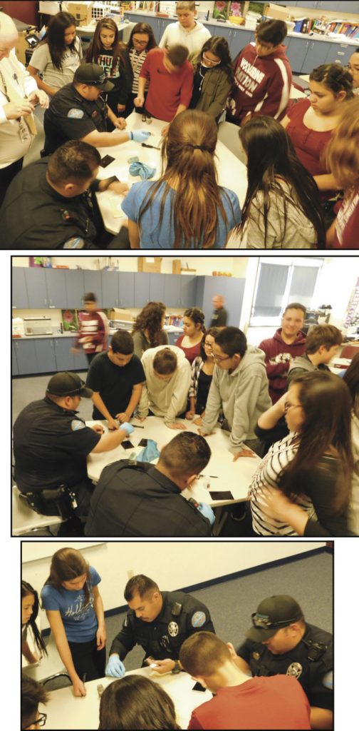 Detective Hillaker, Lieutenant Lininger, Officer Love, and Officer Sanchez demonstrating how to lift finger prints to the WWJHS 7th graders. (Photos credit Lt. Lininger) 